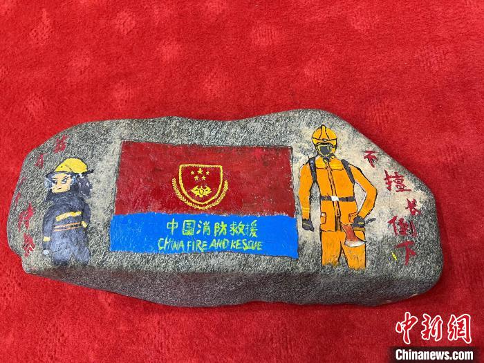 图为玉树消防指战员创作的石头画作品《我有一个特点“不擅长倒下”》。　孙瑞祥 摄